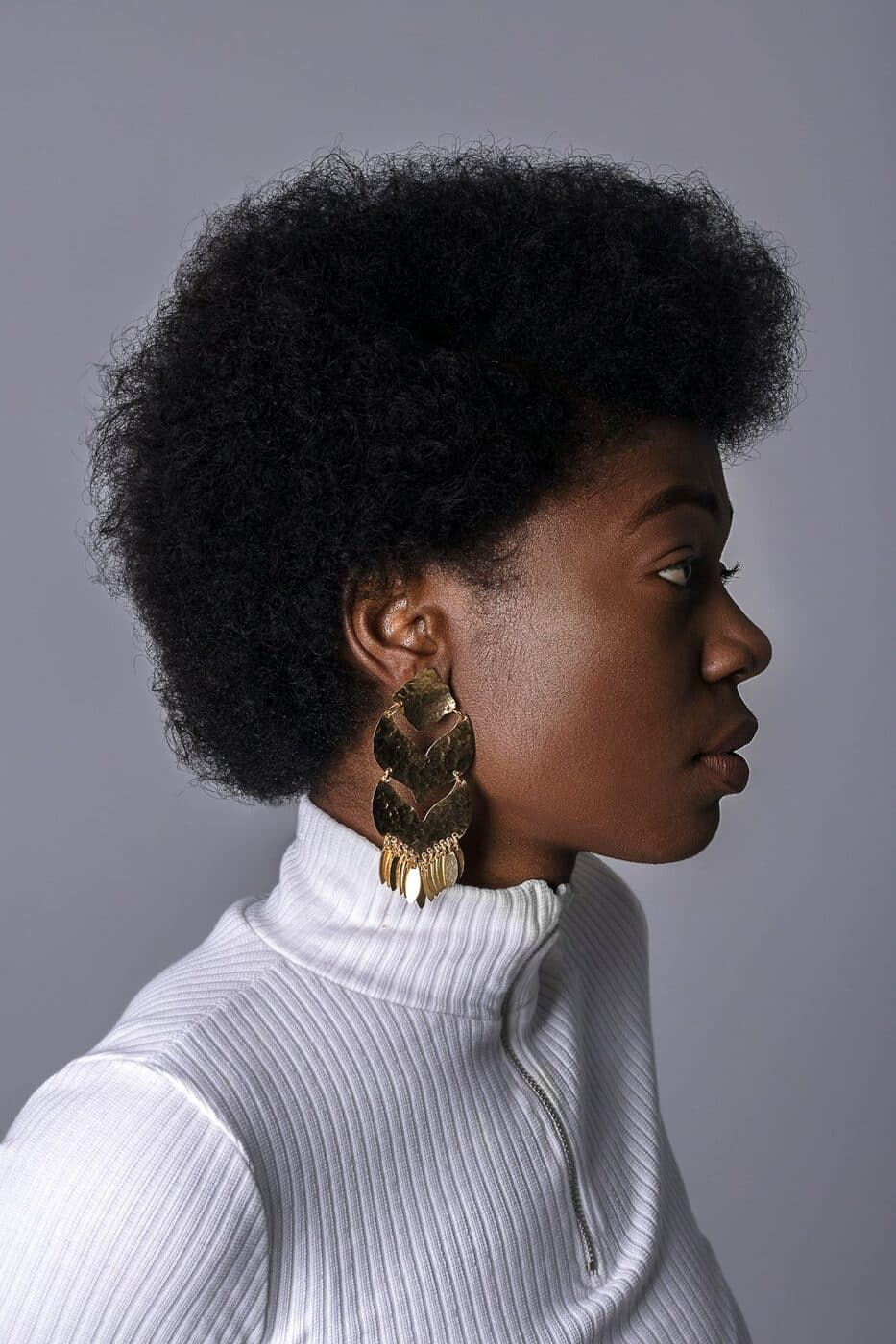 Side profile of a person with a full natural afro.